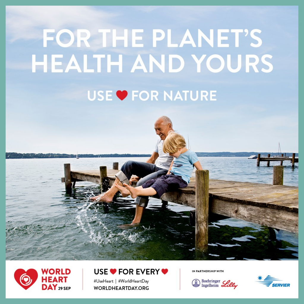 Image of older man and young boy splashing their feet in the water while sitting on a wooden pier. White text at the top reads "For the planet's health and yours. Use *love heart* for nature". Bottom contains logo for World Heart Day 29 Sep. 